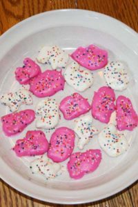 Chocolate Dipped Goodies GF Animal cookies dipped in pink and white chocolate and sprinkled with candy.