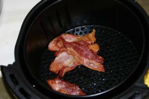 Bacon tends to travel in the air fryer unless it is held in place, there are accessories for that
