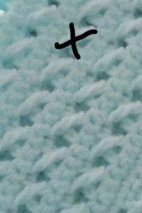 The tr and skipping and crocheting in front of creates an "x" pattern in the bow and arrow baby afghan